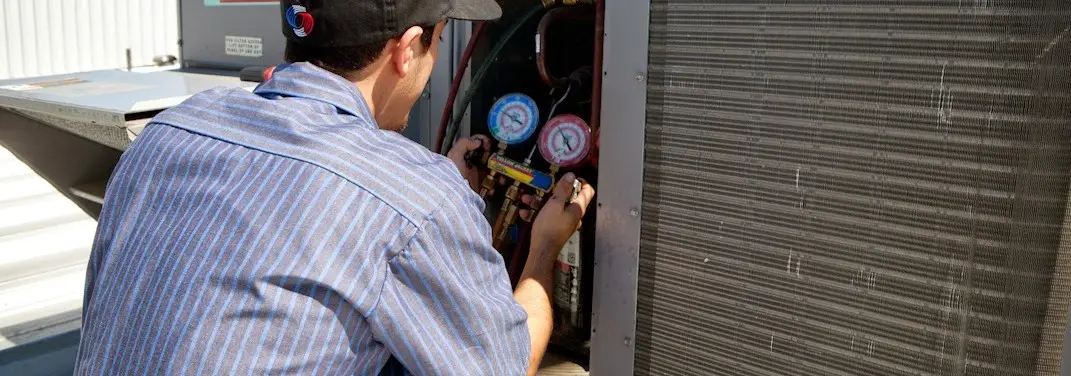 HVAC technician servicing a condenser unit in Copperas Cove